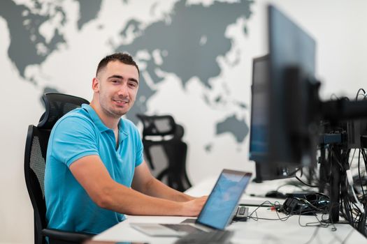 A time to relax. Young tired casual businessman relaxing at the desk in his office. Selective photo. High-quality photo