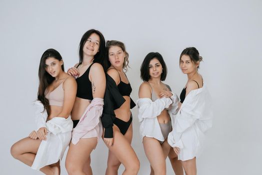 diverse models wearing comfortable underwear, enjoying time together, look at camera having smile and natural unique beauty