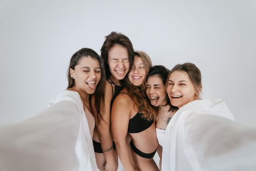 Diverse models wearing comfortable underwear take selfie, look at camera having smile and natural unique beauty