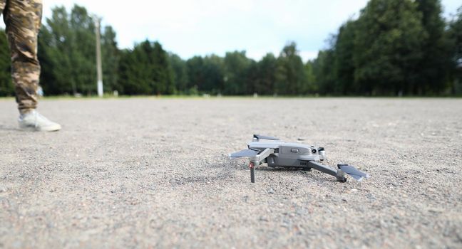 Small digital drone stands on ground. Start service on earth concept