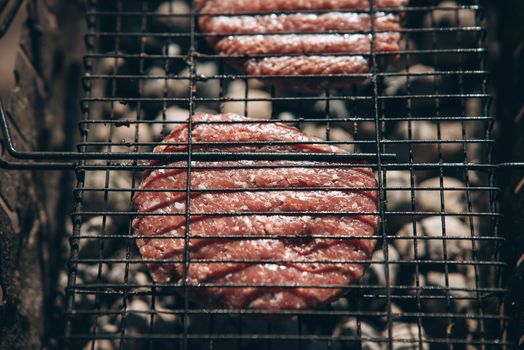 Fresh meat cutlets in a frying grill. Close view.