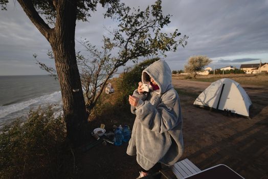 Woman takes a photo on a smartphone of the seascape