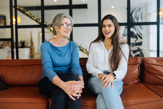 Young woman visiting grandmother at home