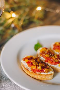 Catering table set service at restaurant before party. Canapes bruschetta with seeds, mozarella and tomatos.