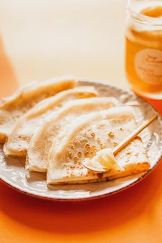 Ghee butter in glass jar and pancakes on table. Healthy eating, breakfast.