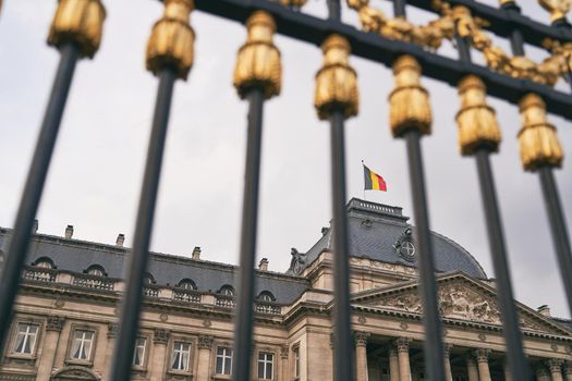 The Royal Palace in Brussels, Belgium. View through the metal fence with golden details