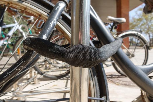 Bicycles parked with safe chain, focus on foreground