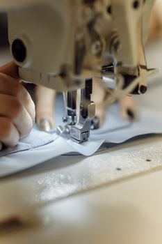 sewing machine scribbling fabric. tailoring at the factory.