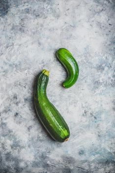 Two fresh organic zucchini on a concrete background. View from above