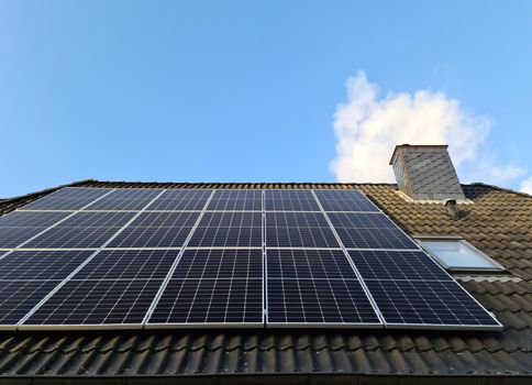 Solar panels producing clean energy on a roof of a residential house