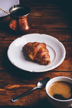 Cup of Turkish Coffee And Croissant on White Plate for Breakfast