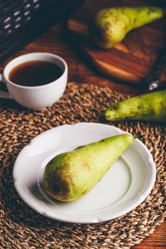 Green Pear on White Plate and Cup of Coffee