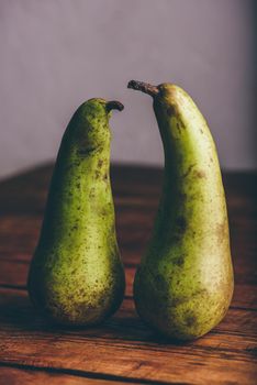 Still Life with Two Green Pears on Wooden Table