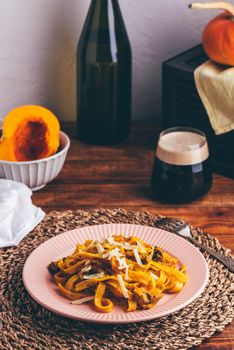 Fettuccine Pasta with Pumpkin Sauce and Mushrooms Garnished with Grated Parmesan Cheese