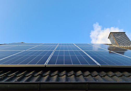 Solar panels producing clean energy on a roof of a residential house