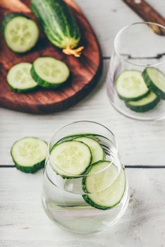 Infused water with sliced cucumber in a drinking glass