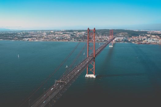 Aerial top view of red 25 De April bridge in Lisbon city, Portugal. High quality photo
