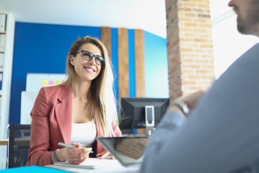 Portrait of workers meet in office, boss lady and man worker at workplace. Colleague use digital tablet for work. Business, office life, conference concept