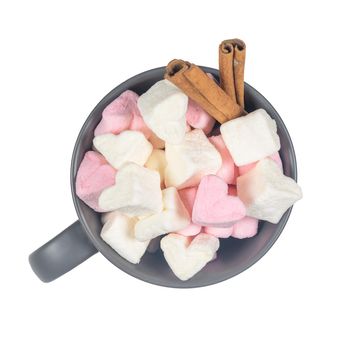 Ceramic cup with sweet heart shape of marshmallow isolated on white background.