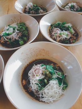 Braised beef clear noodle with meat balls soup stew (Ekaehla meat) with vegetable in bowl for sale at Thai street food market or restaurant in Thailand