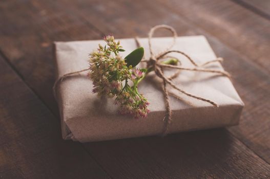 gift wrapped in wrapping kraft paper, decorated with flowers