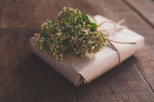 gift wrapped in wrapping kraft paper, decorated with flowers