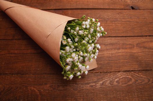 bouquet of chamomile flowers, which lies on a wooden table