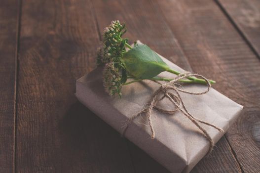 gift wrapped in wrapping kraft paper, decorated with flowers