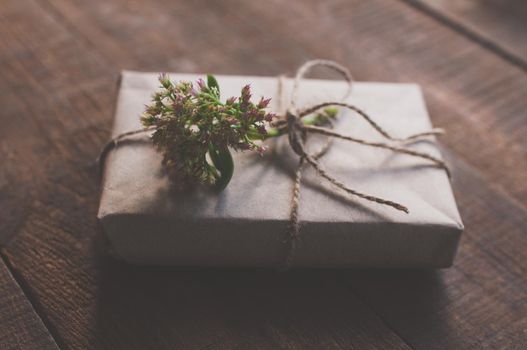 gift wrapped in wrapping kraft paper with a flower on top
