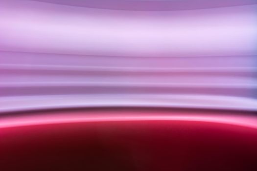 Blurred photo with colorful horizontal lines in pink, lilac, purple. Abstract backdrop.