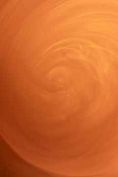 A whirlwind of orange sand. Vertical background abstraction. Backdrop