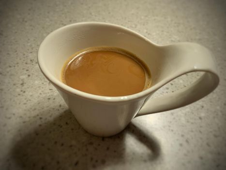 Image of white ceramic coffee mug with shadow.