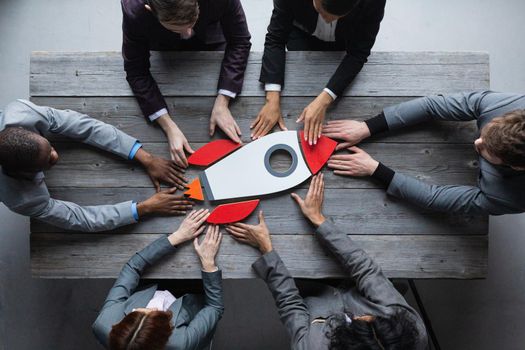 Top view of a business team members launching rocket startup success symbol concept