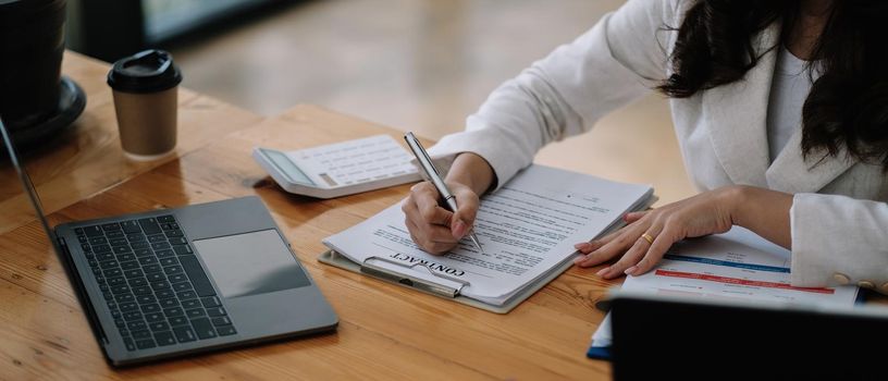 Salesmen are letting the female customers sign the sales contract, Asian woman doing business in the office, Business concept and contract signing