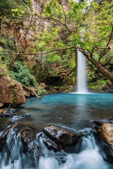 Catarata La Cangreja - Hidden waterfall surrounded by green trees, vegetation, rocks, leaves floating on green and clear water, Rincon de la Vieja National Park, Costa Rica Wilderness