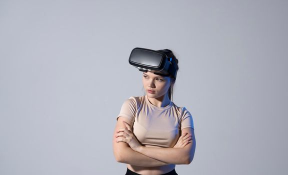 Young woman wearing a virtual reality headset goggles and playing a game with a friends. Future technology concept