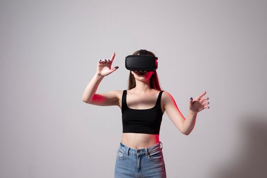 Designer, architect, developer or engineer woman wearing VR goggles and interacts with cyberspace using swipe and stretching gestures while working on a new perspective project