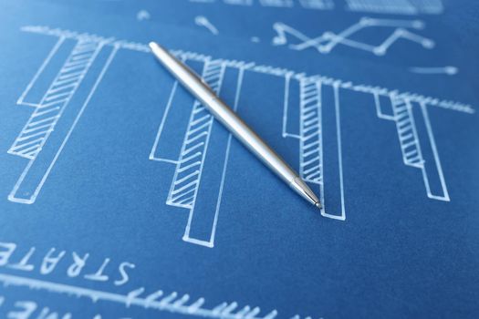 Ballpoint pen lying on blue document with graphs closeup. Profit growth in business concept