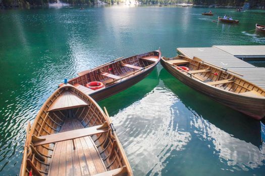 The characteristic lego boats made available to tourists in Lake Braies in the mountain range of the Italian Dolomites 