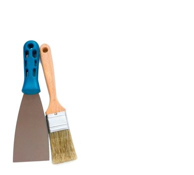 Metal spatula, trowel with plastic handle and paint brush on white background with copyspase