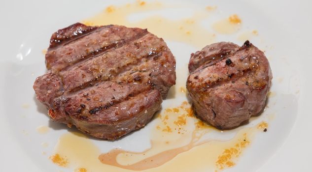 Sirloin steak on white plate, shallow depth of field