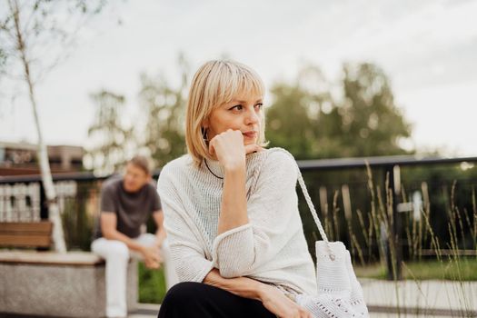 Mature couple in a bad mental condition after a quarrel outdoors. Adult couple man and woman trying to overcome anxiety and disorder after a break-up scene.