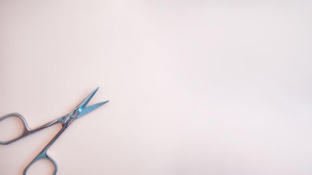 A set of cosmetic tools for manicure and pedicure on a pink background. Gel polishes, nail files, manicure scissors. photo