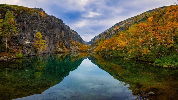 Emerald lake in the Khibiny mountains. Lake with emerald water with rocky shores