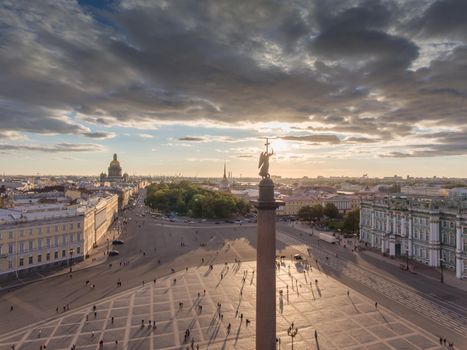 Aerial view of Palace Square and Alexandr Column at sunset, a gold dome of St. Isaac's Cathedral, golden spire of Admiralty building, the Winter Palace, long shadows, cloud. High quality photo