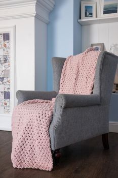 classic chair with brown pillow on carpet in vintage style bedroom interior