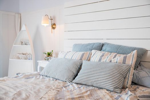 Beige blanket on king-size bed and cacti in gold pots on cupboard in spacious bedroom