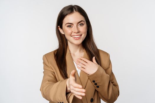 Portrait of smiling businesswoman extend hand for handshake, greeting business partner, saleswoman welcome client, white background.