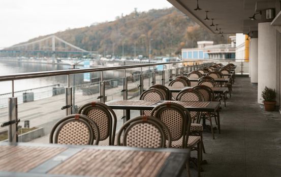 Kyiv, Ukraine, November, 2020. Evening in a empty restaurant with terrace along the Dnipro river coast. Closed on quarantine restaurant. Take away or delivery. High quality photo.