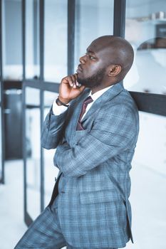 handsome male model in checkered formal suit posing in profile. leader thinks about a new strategy for his team. Close-up. High quality photo